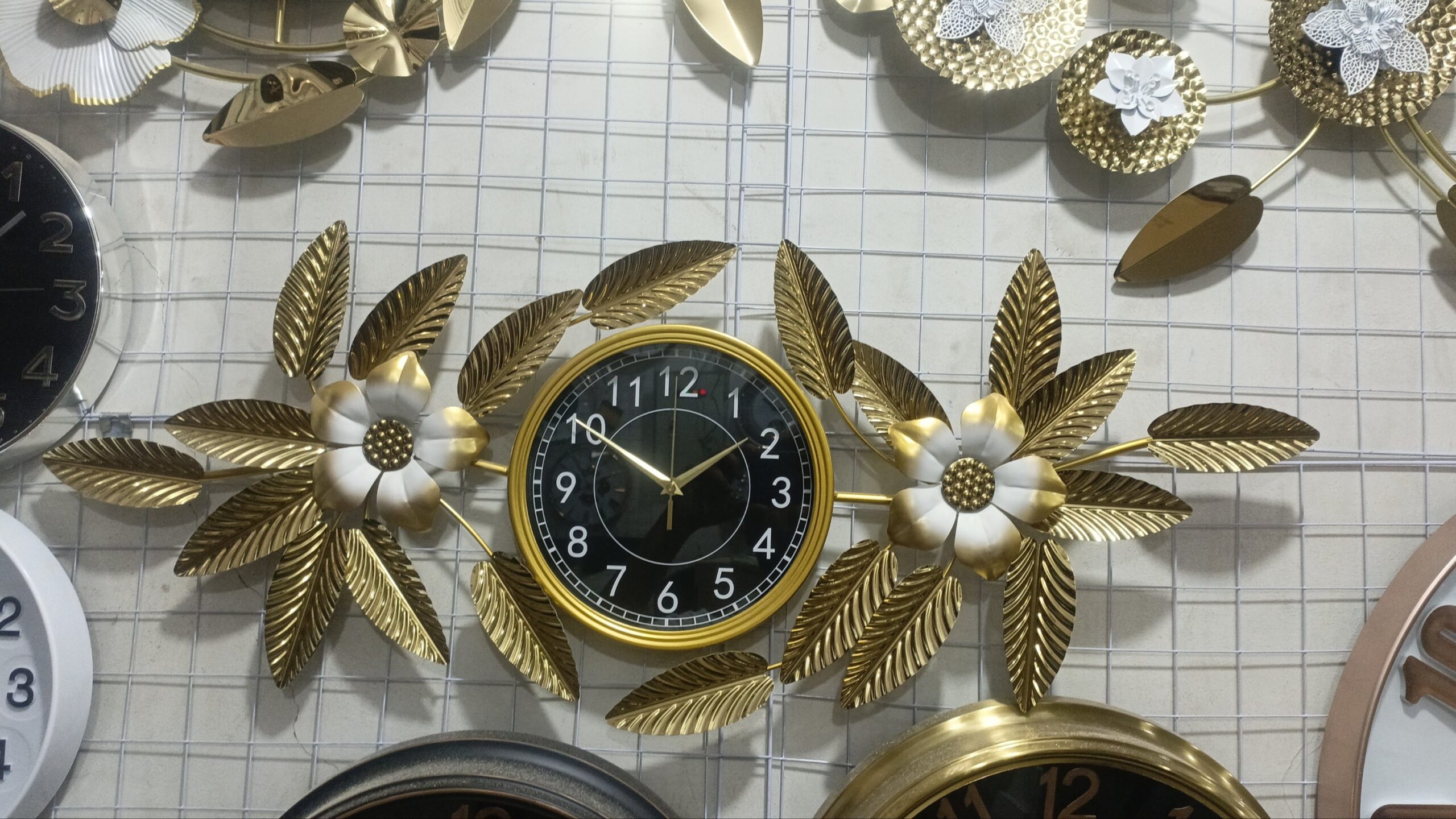 2025/12/1009650791-scaled.jpg Premium Quality Imported Metal Big Wall Clock With Golden & White 0rchid Leaf Design. - Image 1